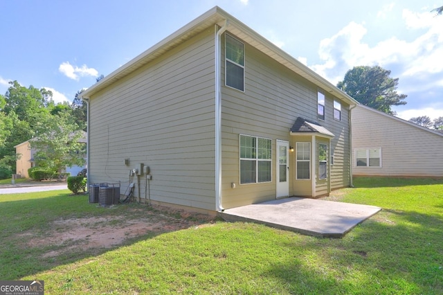 back of house featuring a patio, a lawn, and cooling unit