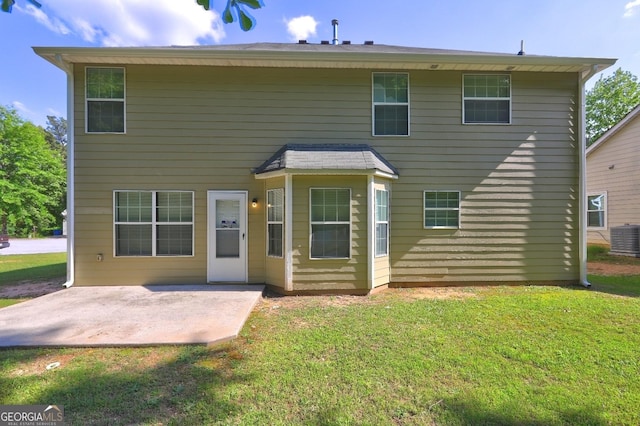 back of property with a patio area, central air condition unit, and a lawn