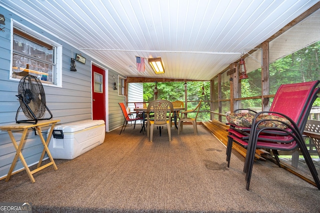 sunroom / solarium featuring outdoor dining area