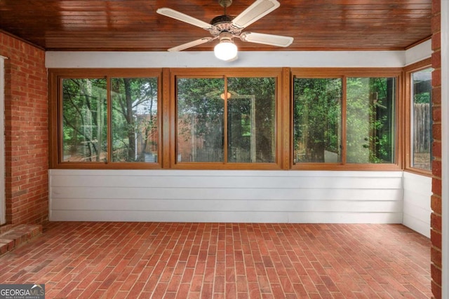 unfurnished sunroom with wooden ceiling and brick flooring