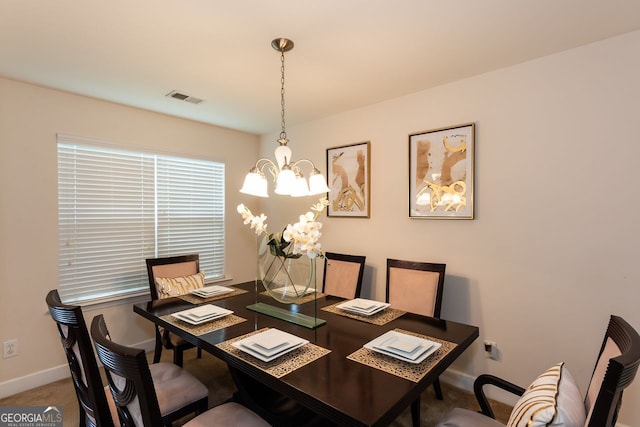 carpeted dining room with a chandelier, baseboards, and an office area