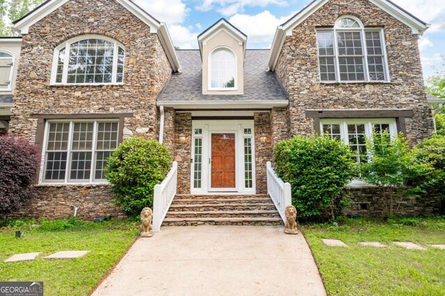 355 Clark Creek Pass, Acworth, GA 30102 - view of front of house with curved driveway, a garage, a front lawn, and a chimney