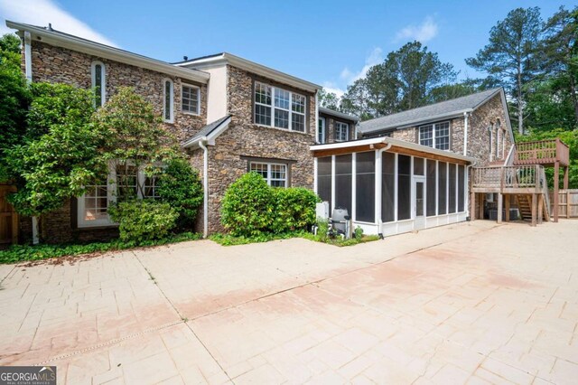 355 Clark Creek Pass, Acworth, GA 30102 - unfurnished sunroom featuring ceiling fan and beam ceiling