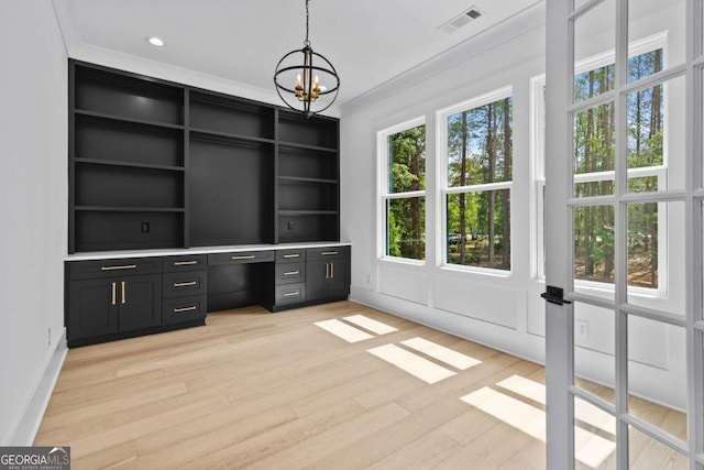 400 Auburn Rd, Auburn, GA 30011 - unfurnished office featuring a chandelier, light wood-style floors, built in desk, built in shelves, and baseboards