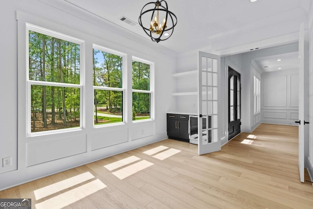 400 Auburn Rd, Auburn, GA 30011 - unfurnished dining area featuring a chandelier, light wood finished floors, french doors, a decorative wall, and recessed lighting