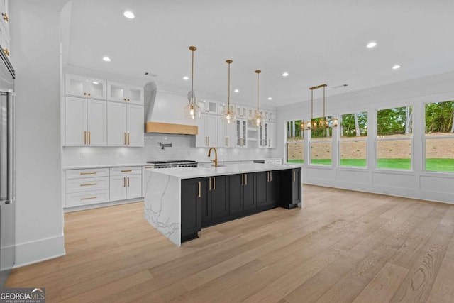 400 Auburn Rd, Auburn, GA 30011 - kitchen featuring premium range hood, white cabinetry, a sink, light wood finished floors, and recessed lighting
