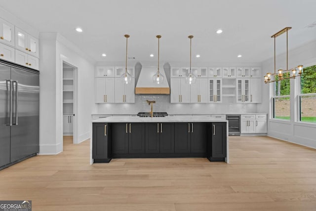400 Auburn Rd, Auburn, GA 30011 - kitchen with built in fridge, wine cooler, custom exhaust hood, white cabinets, and light countertops