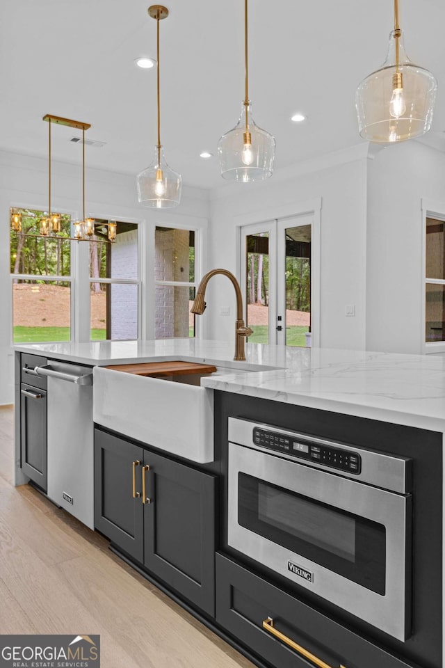 400 Auburn Rd, Auburn, GA 30011 - kitchen featuring appliances with stainless steel finishes, a sink, french doors, ornamental molding, and pendant lighting