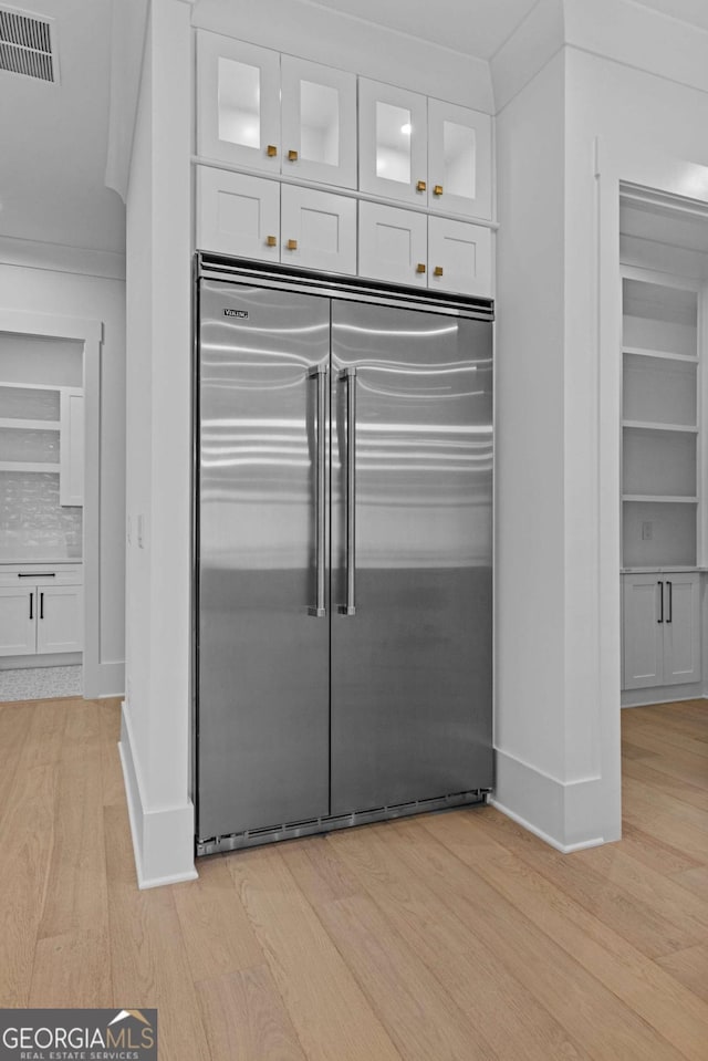 400 Auburn Rd, Auburn, GA 30011 - kitchen featuring stainless steel built in fridge, light wood finished floors, white cabinets, and ornamental molding