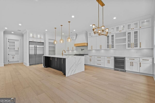 400 Auburn Rd, Auburn, GA 30011 - kitchen with built in fridge, wine cooler, custom range hood, white cabinetry, and light wood finished floors