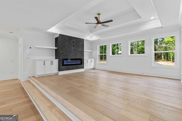 400 Auburn Rd, Auburn, GA 30011 - unfurnished living room with a tray ceiling, light wood finished floors, a high end fireplace, ceiling fan, and crown molding