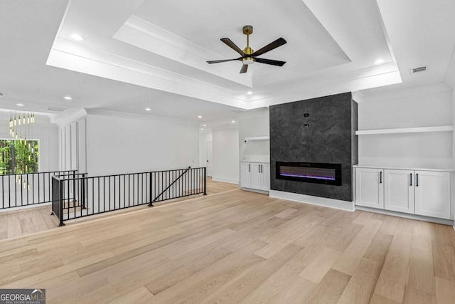 400 Auburn Rd, Auburn, GA 30011 - unfurnished living room featuring a tray ceiling, light wood finished floors, a ceiling fan, recessed lighting, and a fireplace
