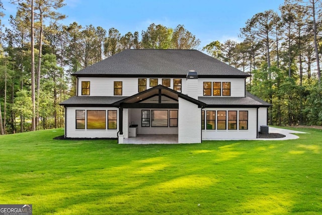 400 Auburn Rd, Auburn, GA 30011 - back of house featuring a patio, a yard, and roof with shingles