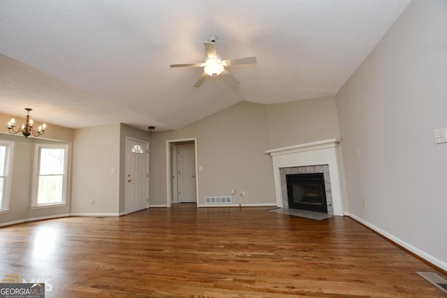 122 Wilson Cir, Carrollton, GA 30117 - unfurnished living room with a fireplace, wood finished floors, ceiling fan, a chandelier, and baseboards