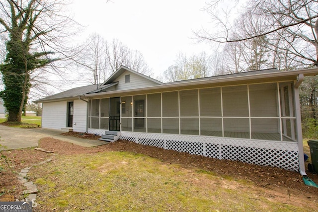 view of front facade with a sunroom