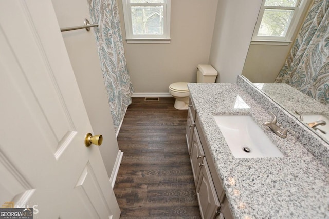 bathroom featuring toilet, wood finished floors, baseboards, vanity, and a shower with shower curtain