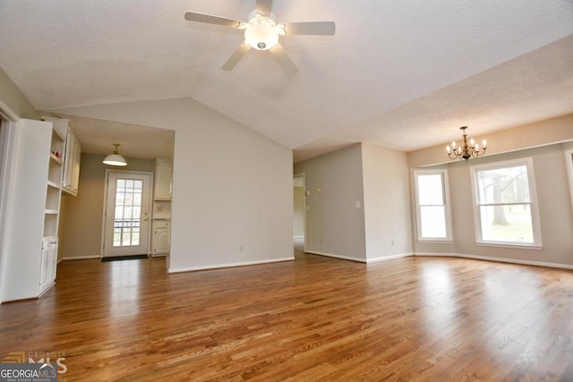 122 Wilson Cir, Carrollton, GA 30117 - unfurnished living room with wood finished floors, a chandelier, a textured ceiling, ceiling fan, and baseboards