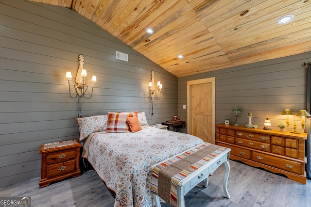 bedroom featuring vaulted ceiling, wood ceiling, wooden walls, wood finished floors, and recessed lighting