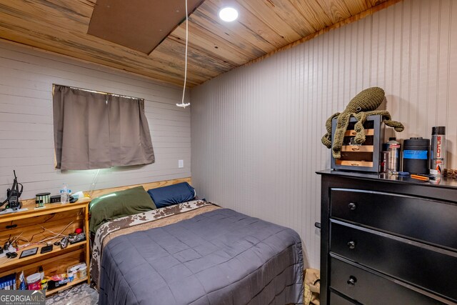 bedroom featuring wood ceiling and wood walls