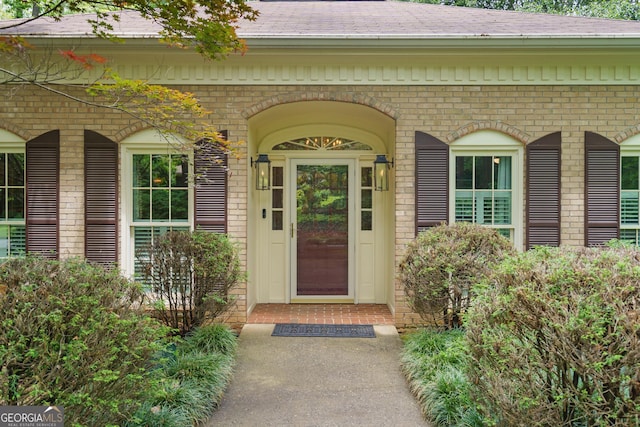 11190 Hembree Springs Dr, Roswell, GA 30076 - view of exterior entry featuring brick siding and roof with shingles