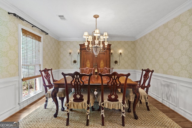 11190 Hembree Springs Dr, Roswell, GA 30076 - dining area featuring wood finished floors, a chandelier, wainscoting, and ornamental molding