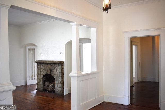 210 E Church St, Sandersville, GA 31082 - unfurnished living room with wood finished floors, a fireplace, arched walkways, crown molding, and baseboards