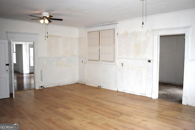 210 E Church St, Sandersville, GA 31082 - empty room with ceiling fan, wood finished floors, and ornamental molding
