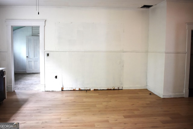 210 E Church St, Sandersville, GA 31082 - spare room featuring light wood-type flooring and ornamental molding