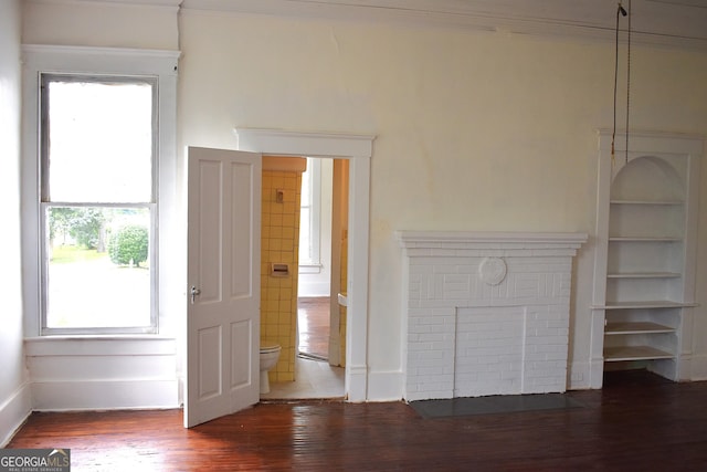 210 E Church St, Sandersville, GA 31082 - unfurnished living room with wood finished floors and baseboards