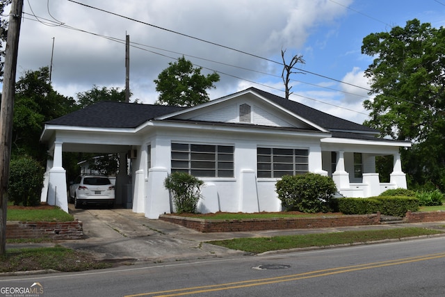 210 E Church St, Sandersville, GA 31082 - view of front facade with concrete driveway, a carport, and a shingled roof