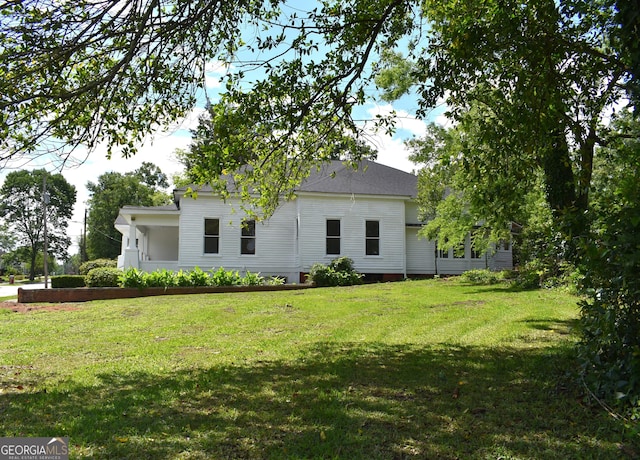 210 E Church St, Sandersville, GA 31082 - view of property exterior featuring a lawn