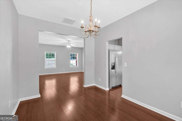unfurnished dining area with a chandelier, a ceiling fan, baseboards, and dark wood-style floors