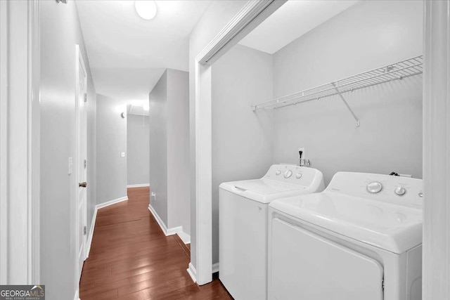 laundry area featuring washer and dryer, dark wood-type flooring, baseboards, and attic access