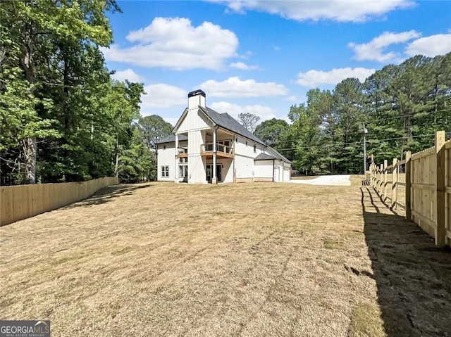 1461 Leach Dr, Lawrenceville, GA 30045 - back of property featuring a fenced backyard, a balcony, and a garage