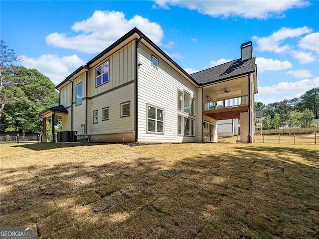 1461 Leach Dr, Lawrenceville, GA 30045 - rear view of house with a ceiling fan, board and batten siding, and a chimney