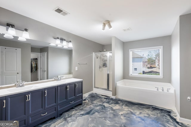 2430 Redbud Meadow Ln, Douglasville, GA 30135 - full bathroom with a shower stall, a bath, double vanity, a spacious closet, and baseboards