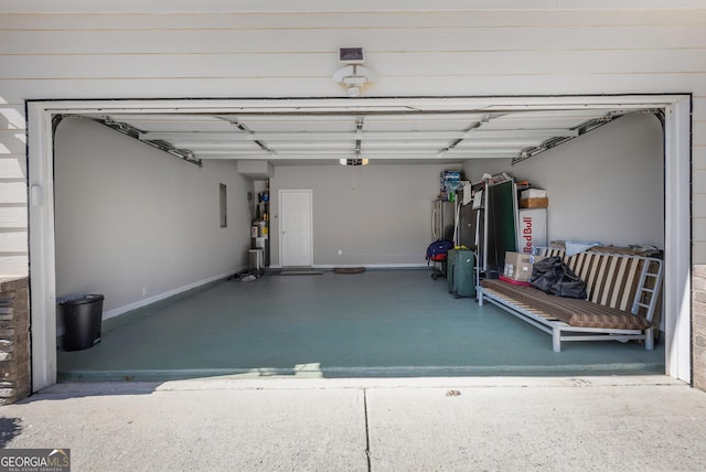 2430 Redbud Meadow Ln, Douglasville, GA 30135 - garage with baseboards and a garage door opener