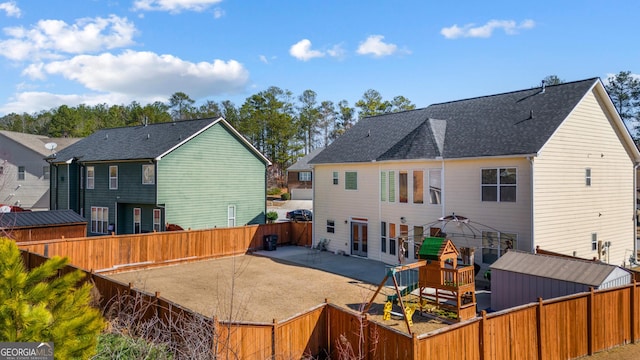 2430 Redbud Meadow Ln, Douglasville, GA 30135 - rear view of property with a patio, a fenced backyard, and roof with shingles