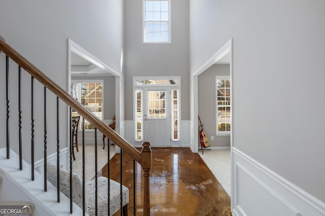 2430 Redbud Meadow Ln, Douglasville, GA 30135 - entryway with healthy amount of natural light, wainscoting, stairway, and a high ceiling