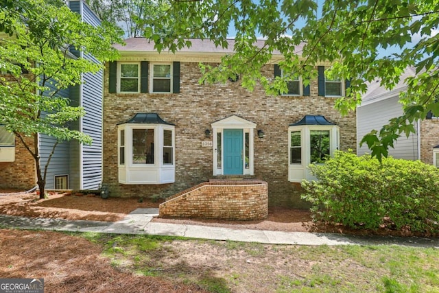 colonial-style house featuring brick siding