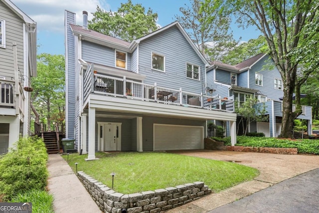 view of front facade with an attached garage, concrete driveway, a front lawn, and stairway