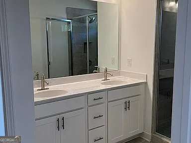 1616 Avery Way, Tucker, GA 30084 - full bathroom featuring double vanity and a shower with door