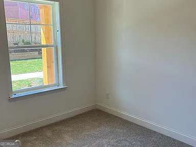 1616 Avery Way, Tucker, GA 30084 - empty room featuring baseboards and dark carpet