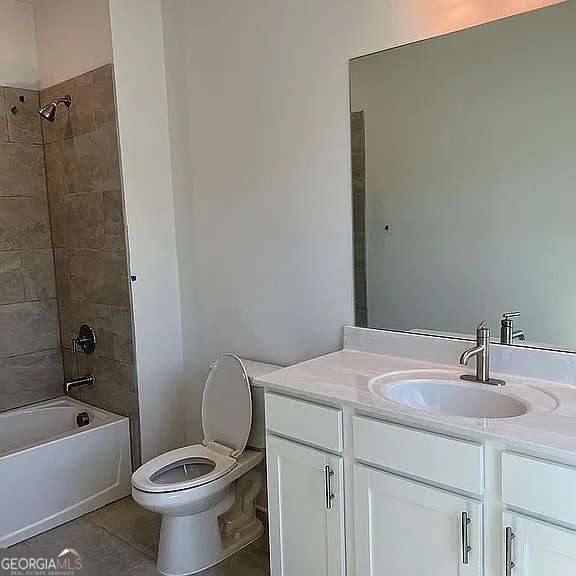 1616 Avery Way, Tucker, GA 30084 - bathroom with vanity, toilet, tile patterned flooring, and washtub / shower combination