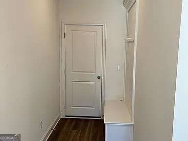 1616 Avery Way, Tucker, GA 30084 - doorway to outside featuring dark wood-style flooring and baseboards