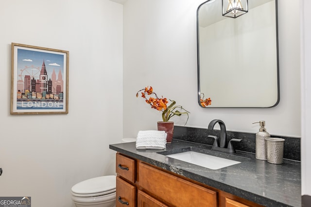 half bath with vanity and toilet
