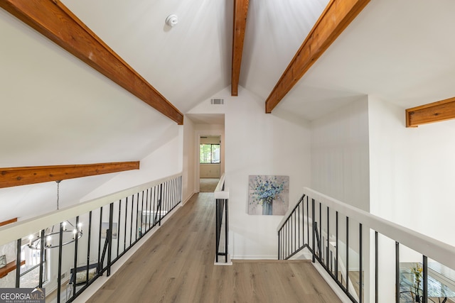 hall with wood finished floors, an upstairs landing, baseboards, and a chandelier