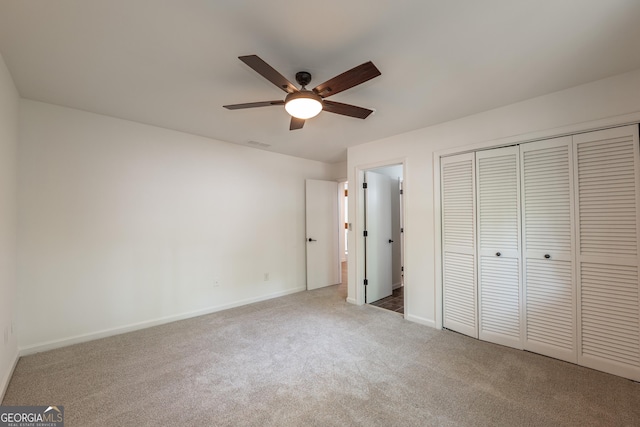 unfurnished bedroom with carpet flooring, baseboards, a closet, and ceiling fan