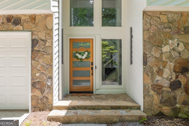 doorway to property featuring stone siding