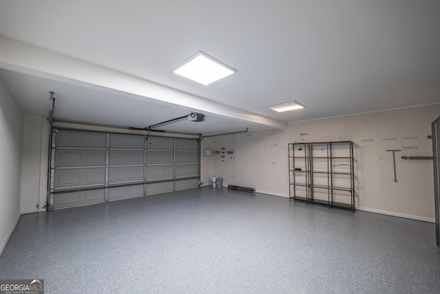 garage featuring baseboards and a garage door opener